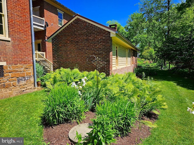 view of property exterior with a lawn