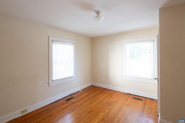 spare room featuring hardwood / wood-style floors