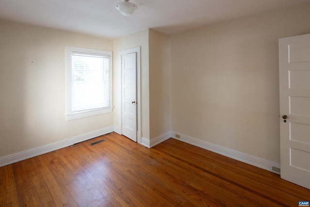 unfurnished room with hardwood / wood-style floors