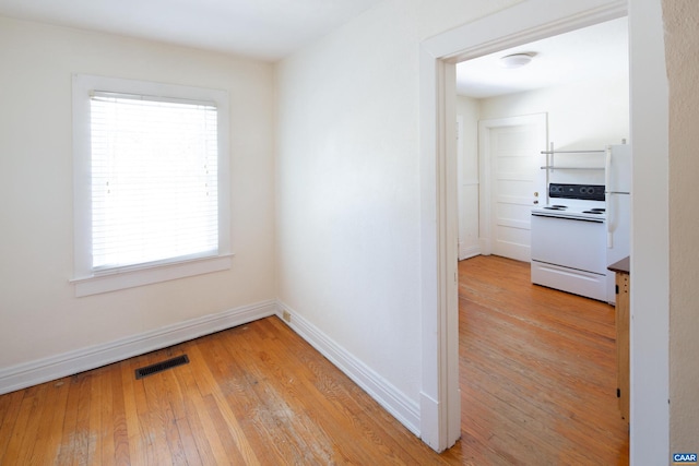 hallway with light hardwood / wood-style floors