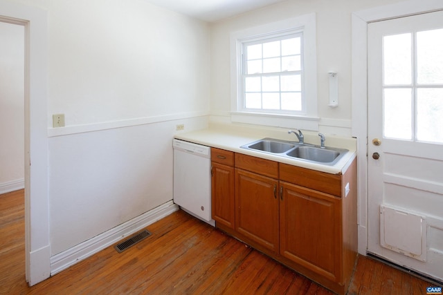 kitchen featuring dark hardwood / wood-style flooring, sink, and white dishwasher