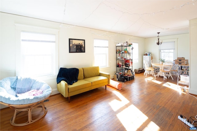 living room featuring an inviting chandelier and wood-type flooring