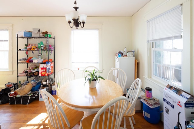 dining room featuring an inviting chandelier and wood-type flooring