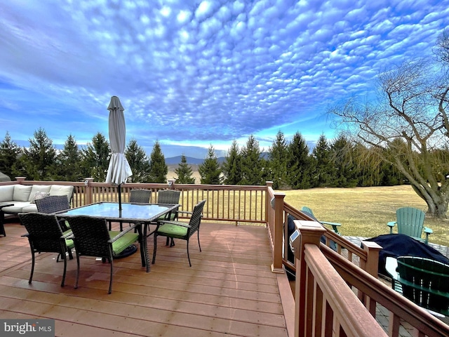 wooden terrace featuring a yard and an outdoor hangout area