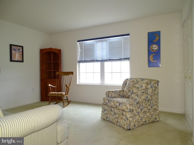 sitting room with carpet and baseboards