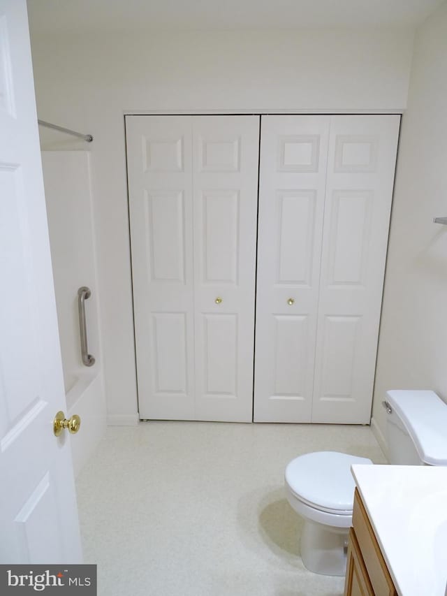 bathroom with toilet, bathtub / shower combination, a closet, and vanity