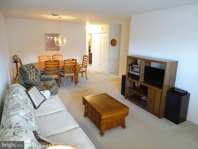 living area featuring light carpet and a notable chandelier