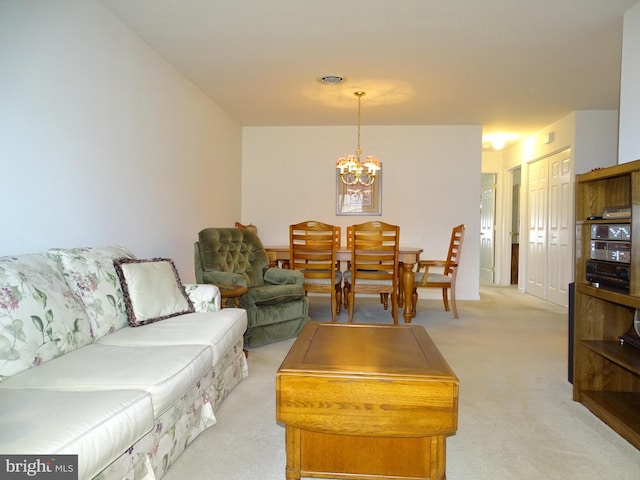 living area featuring light carpet, visible vents, and a notable chandelier