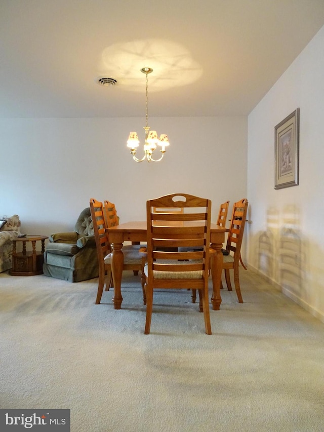 dining space featuring a chandelier, carpet, and visible vents