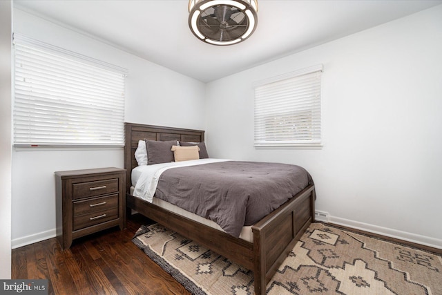 bedroom with dark hardwood / wood-style flooring