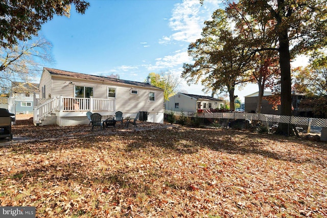 back of property featuring a fire pit