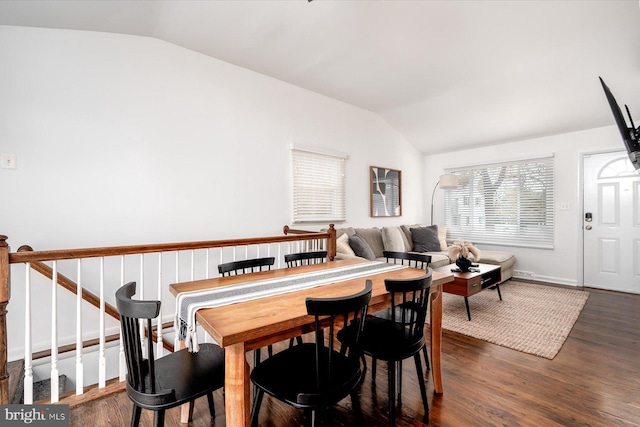 dining space with dark hardwood / wood-style flooring and vaulted ceiling