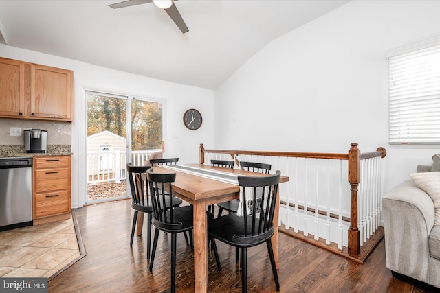 dining room with hardwood / wood-style flooring, ceiling fan, and lofted ceiling