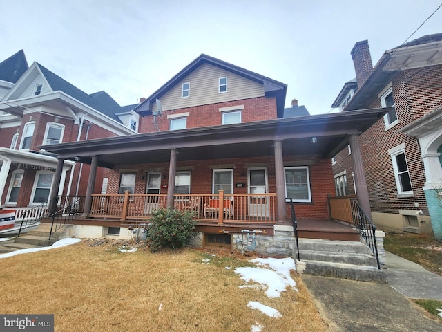 view of front of house featuring covered porch and a front yard