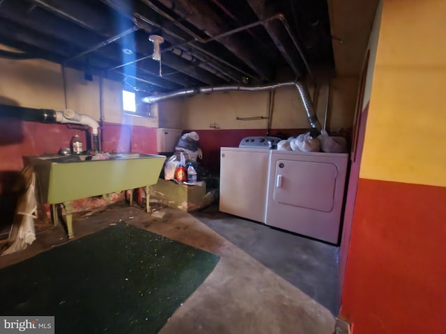 basement featuring washer and clothes dryer and sink