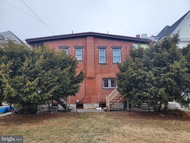 view of side of home featuring a yard