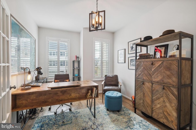 office with a notable chandelier and wood-type flooring