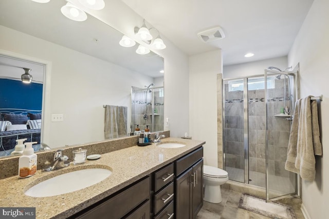 bathroom featuring walk in shower, vanity, and toilet