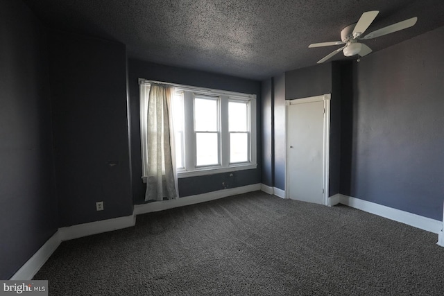 spare room featuring ceiling fan, a textured ceiling, and carpet