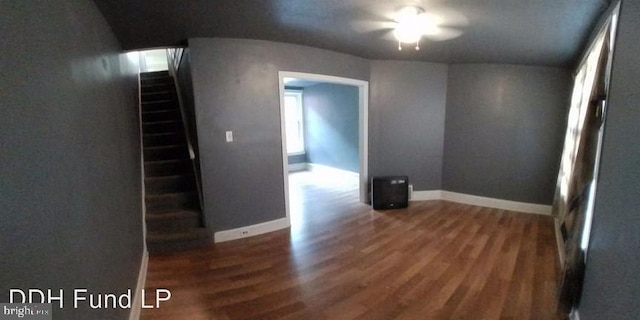 empty room with dark hardwood / wood-style flooring