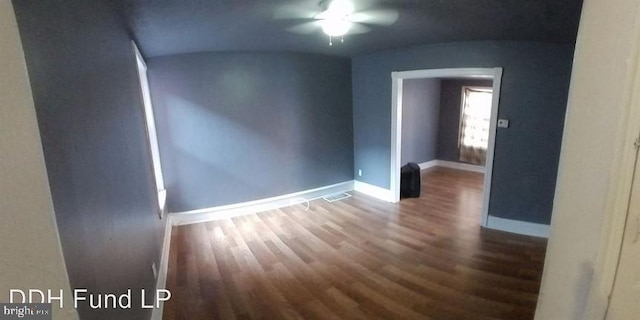 spare room with dark wood-type flooring and ceiling fan