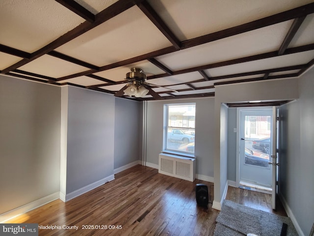 entryway with hardwood / wood-style flooring, ceiling fan, radiator heating unit, and beam ceiling