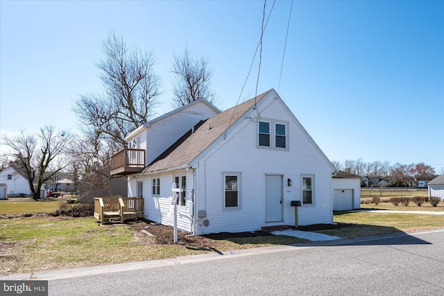 bungalow featuring a front lawn, roof with shingles, and a balcony