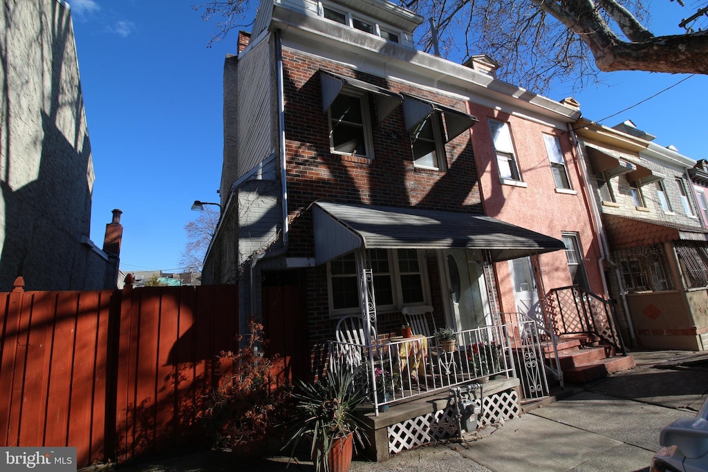 rear view of house featuring a porch