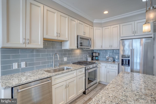 kitchen with high end appliances, decorative light fixtures, light stone countertops, and sink