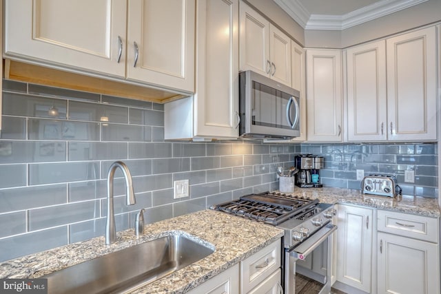 kitchen featuring sink, appliances with stainless steel finishes, light stone counters, ornamental molding, and decorative backsplash