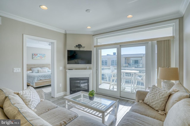 living room with crown molding and light hardwood / wood-style flooring