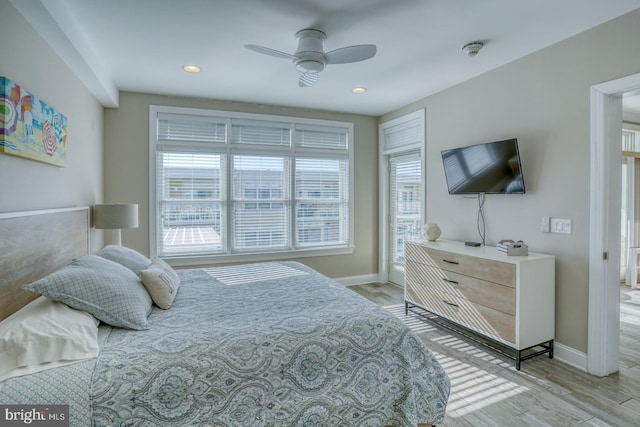 bedroom with ceiling fan and light wood-type flooring