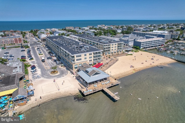 bird's eye view featuring a water view and a beach view