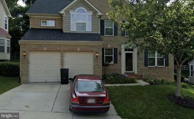 view of front of property featuring a garage and a front yard