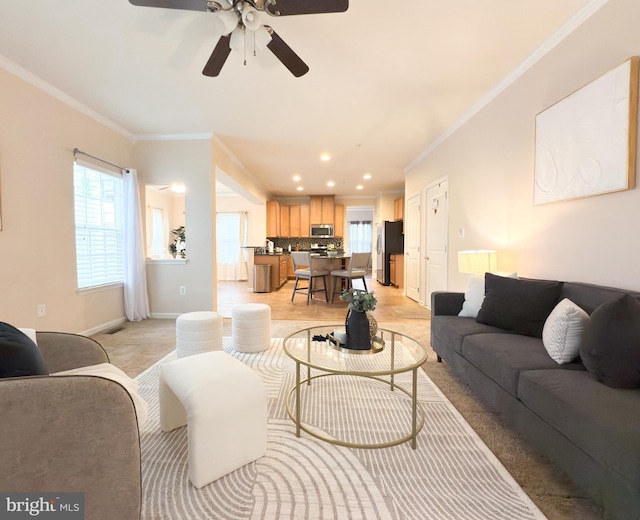 living room featuring ornamental molding and ceiling fan