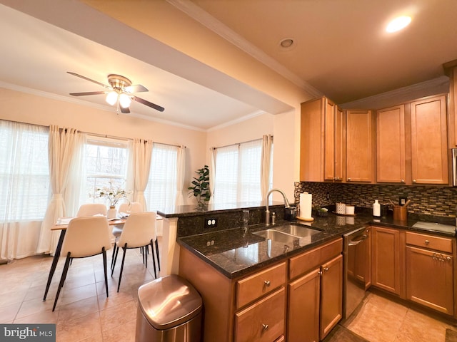 kitchen with sink, stainless steel dishwasher, and kitchen peninsula