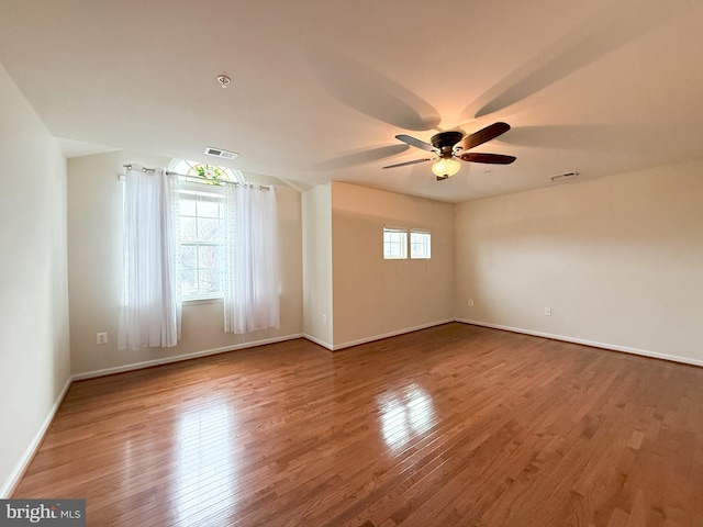 unfurnished room with ceiling fan and hardwood / wood-style floors