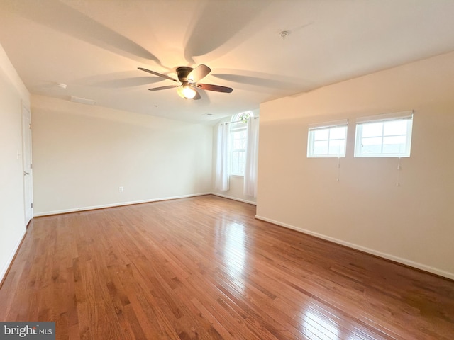 unfurnished room with hardwood / wood-style flooring and ceiling fan