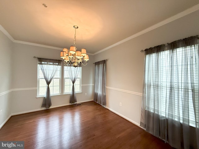 unfurnished dining area featuring crown molding, dark hardwood / wood-style flooring, and a notable chandelier