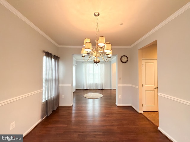 unfurnished dining area with ornamental molding, dark hardwood / wood-style floors, and a chandelier