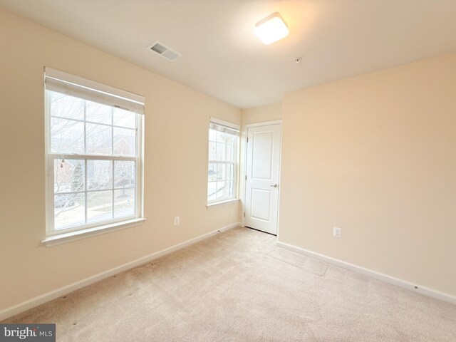 spare room with light carpet