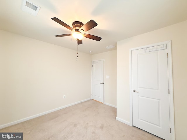 unfurnished bedroom with ceiling fan and light colored carpet