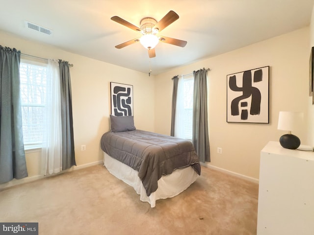 bedroom with light colored carpet and ceiling fan