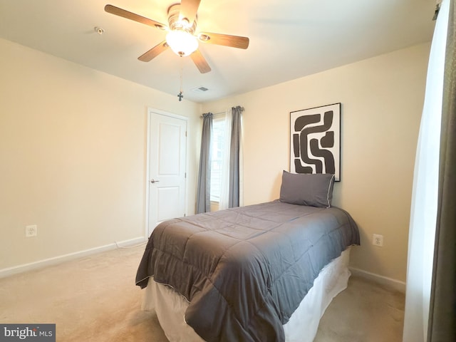 bedroom with light colored carpet and ceiling fan