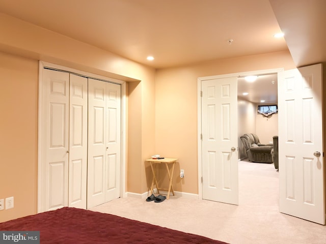 bedroom with light colored carpet and a closet