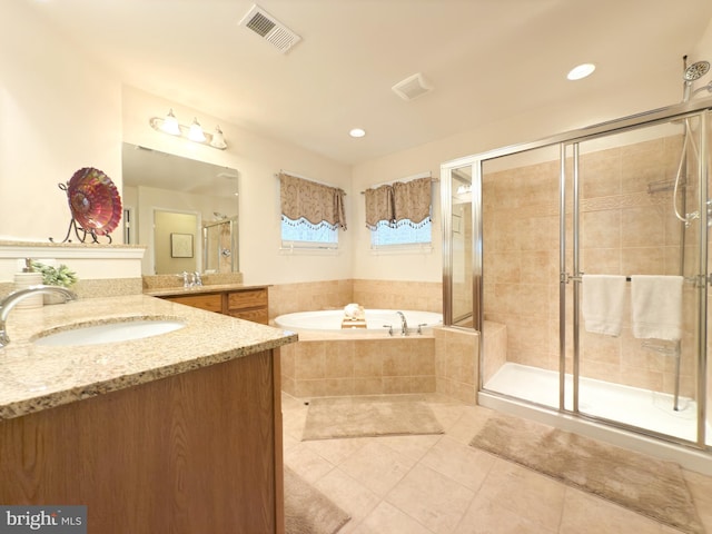 bathroom with vanity, tile patterned floors, and plus walk in shower