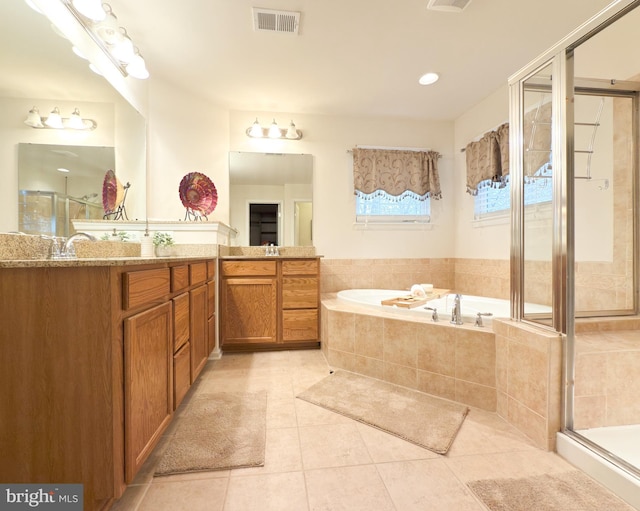 bathroom featuring tile patterned floors, independent shower and bath, and vanity