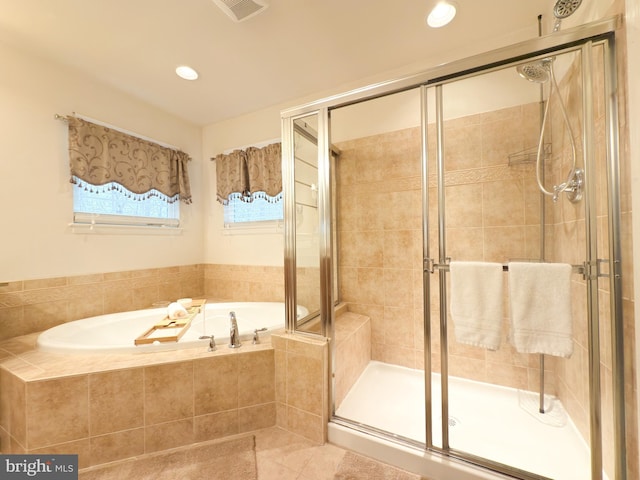 bathroom featuring tile patterned floors and shower with separate bathtub