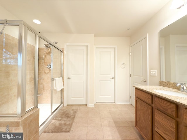 bathroom featuring vanity and a shower with door