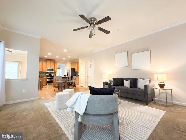 carpeted living room with crown molding and ceiling fan